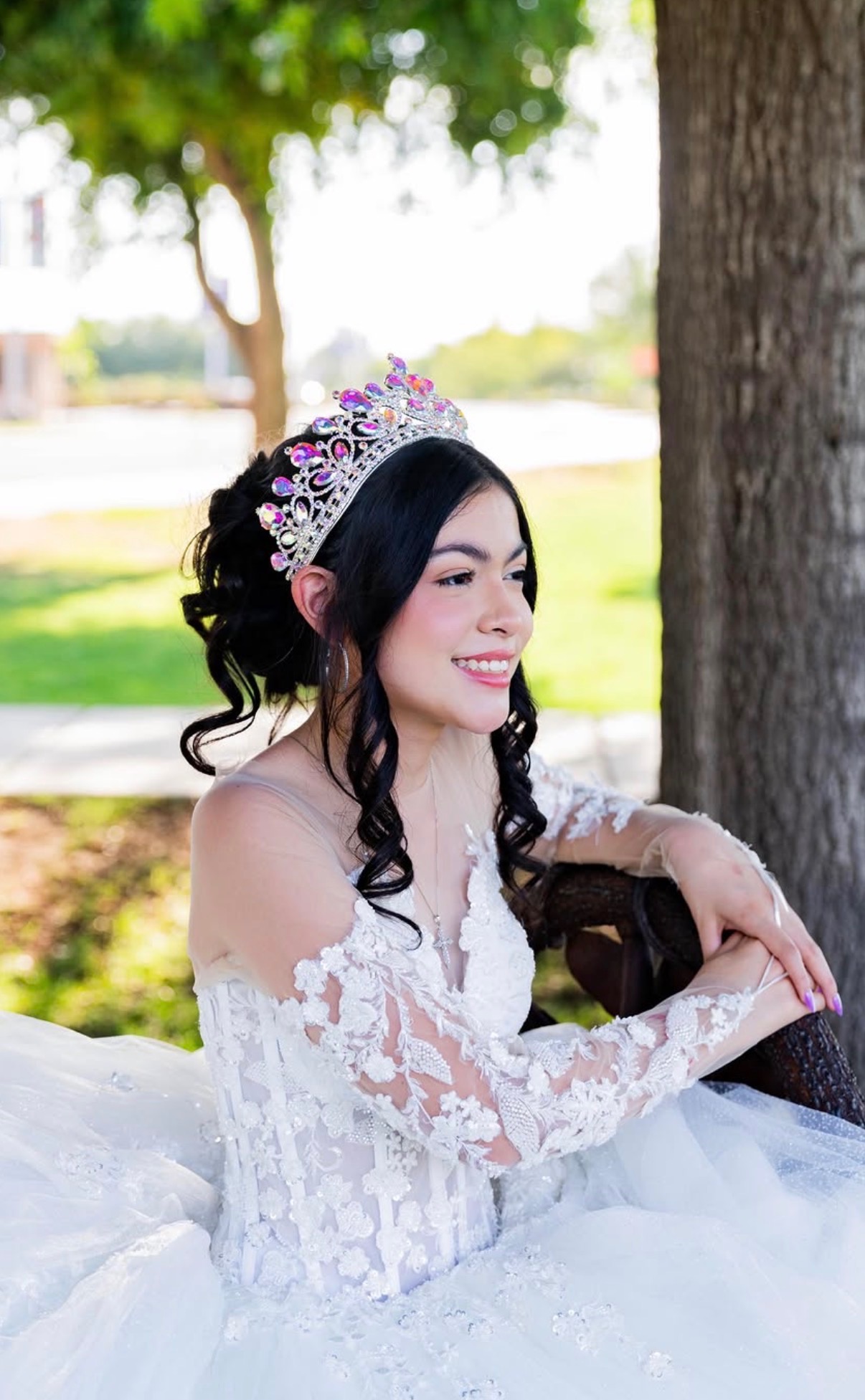 Quinceañera glam makeup with soft curls and tiara in Arizona